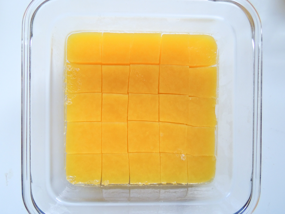 Square glass container with orange gummies