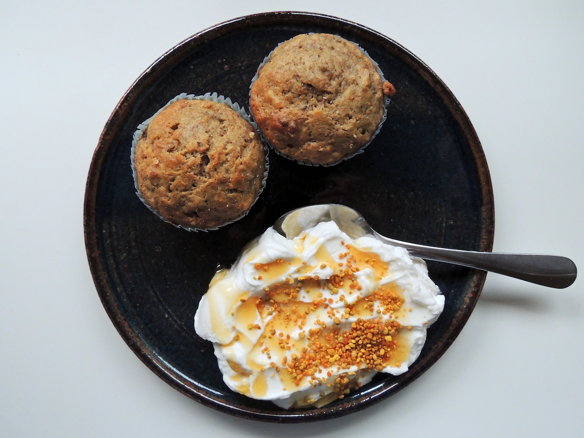 Two muffins with yogurt, honey, and bee pollen